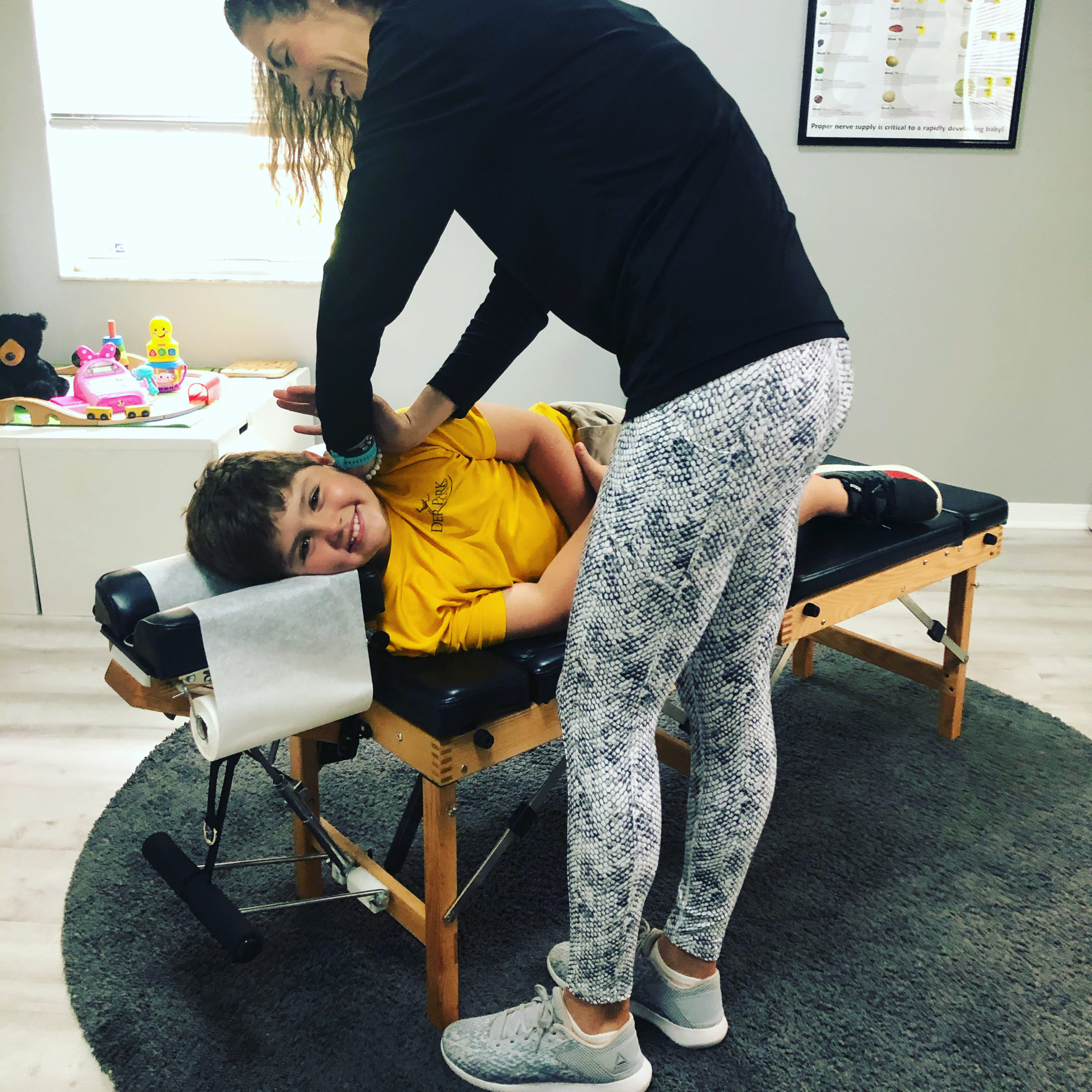 All smiles during a pediatric chiropractic adjustment