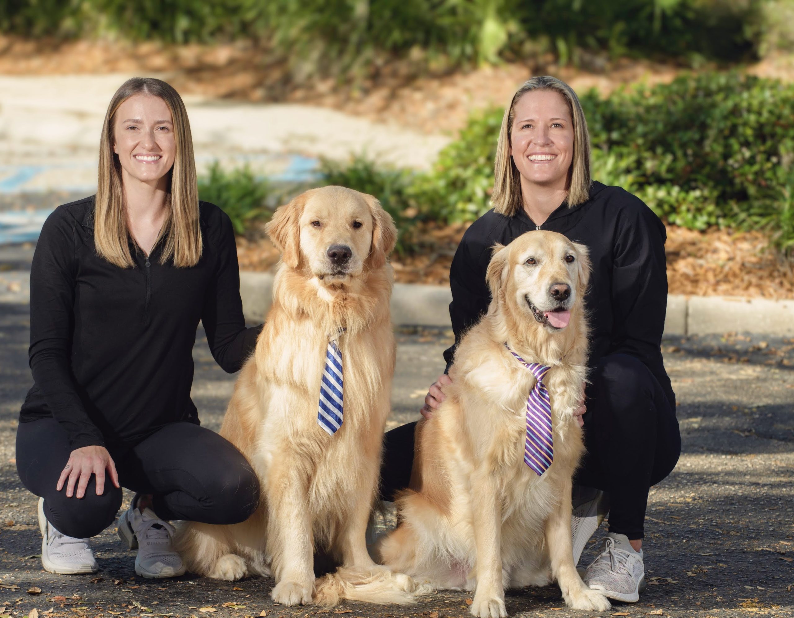 Dr. Rachel and Dr. Danielle outsite with Goose and Cooper companion dogs