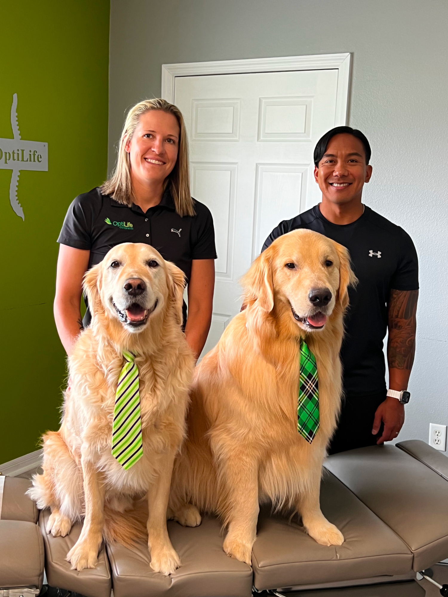 Dr. Danielle Hoeffner and Dr. Allen Molina - Optilife Chiropractors with service dogs