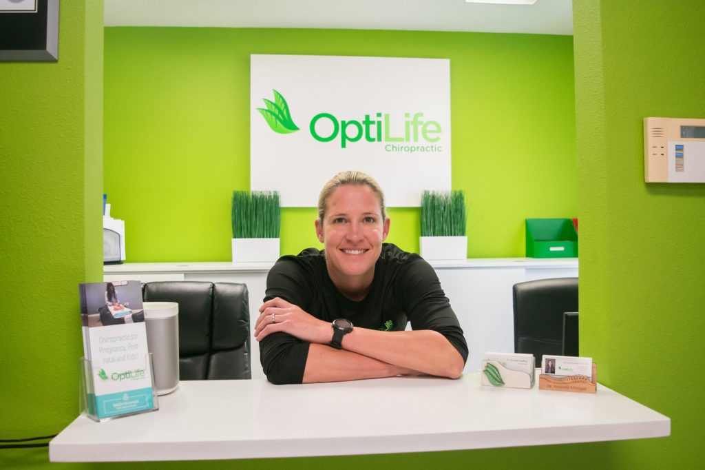 Welcome to Optilife - Dr. Danielle standing in receptionist area