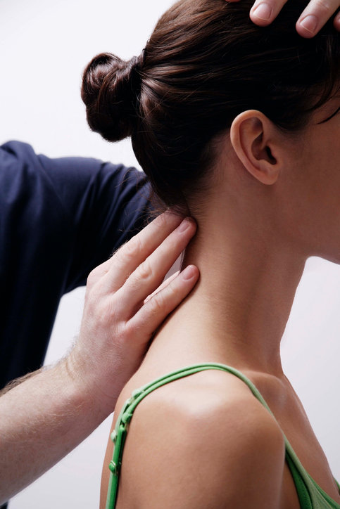 Dr.  Examining a patients neck to treat neck pain in Tampa, Fl