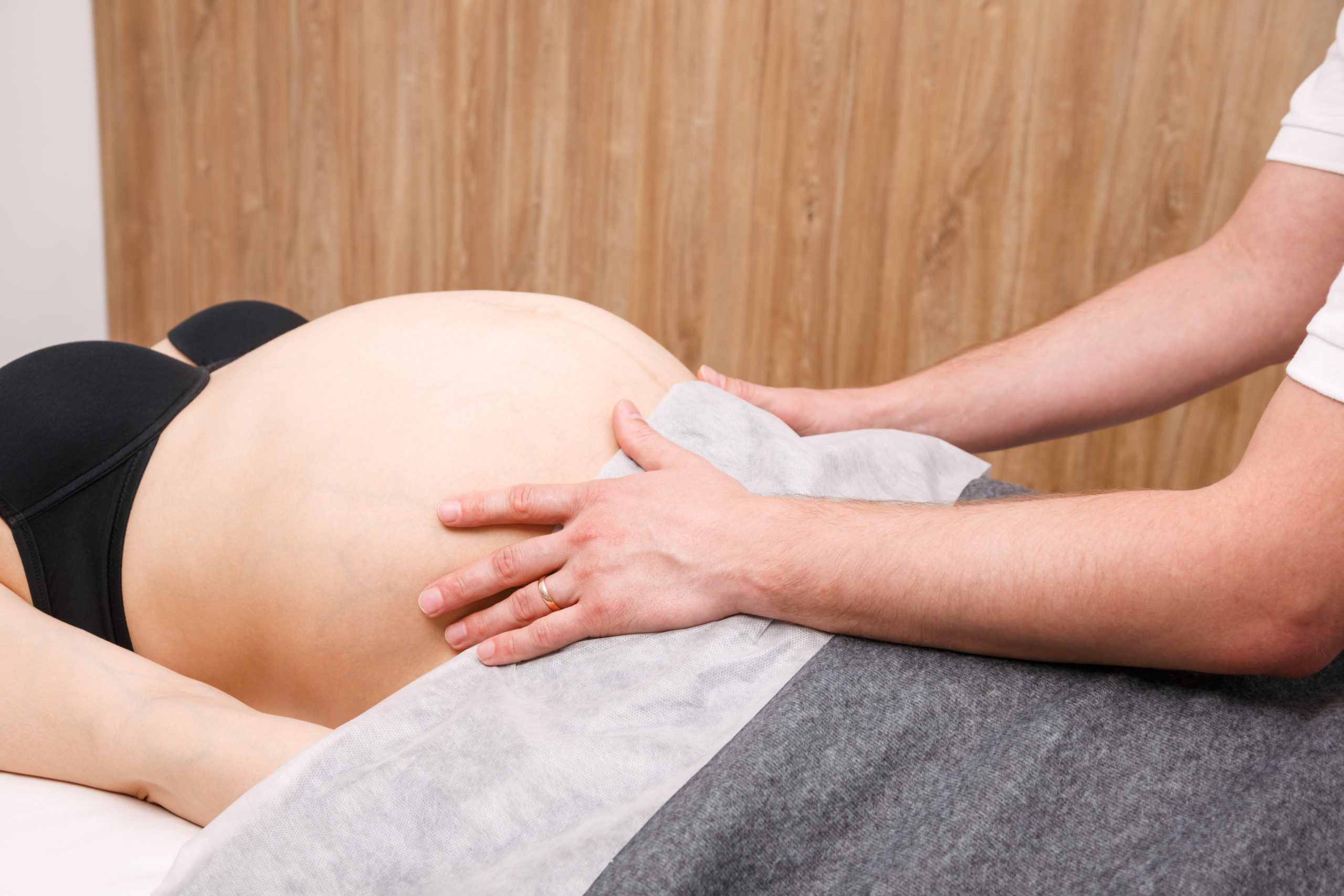Pregnant woman receiving osteopathic treatment of her belly
